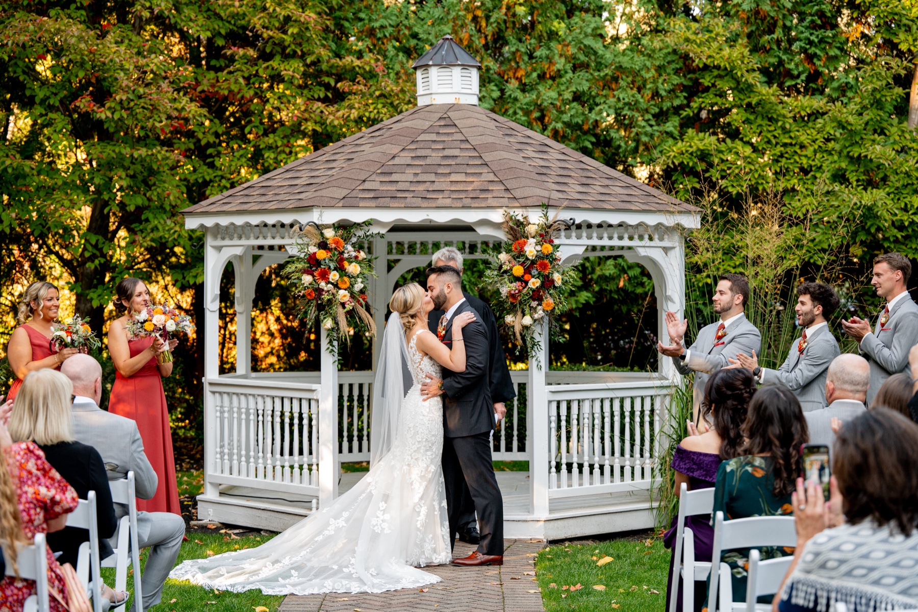 bride and groom kissing in front of the gazebo at their chocksett inn wedding ceremony