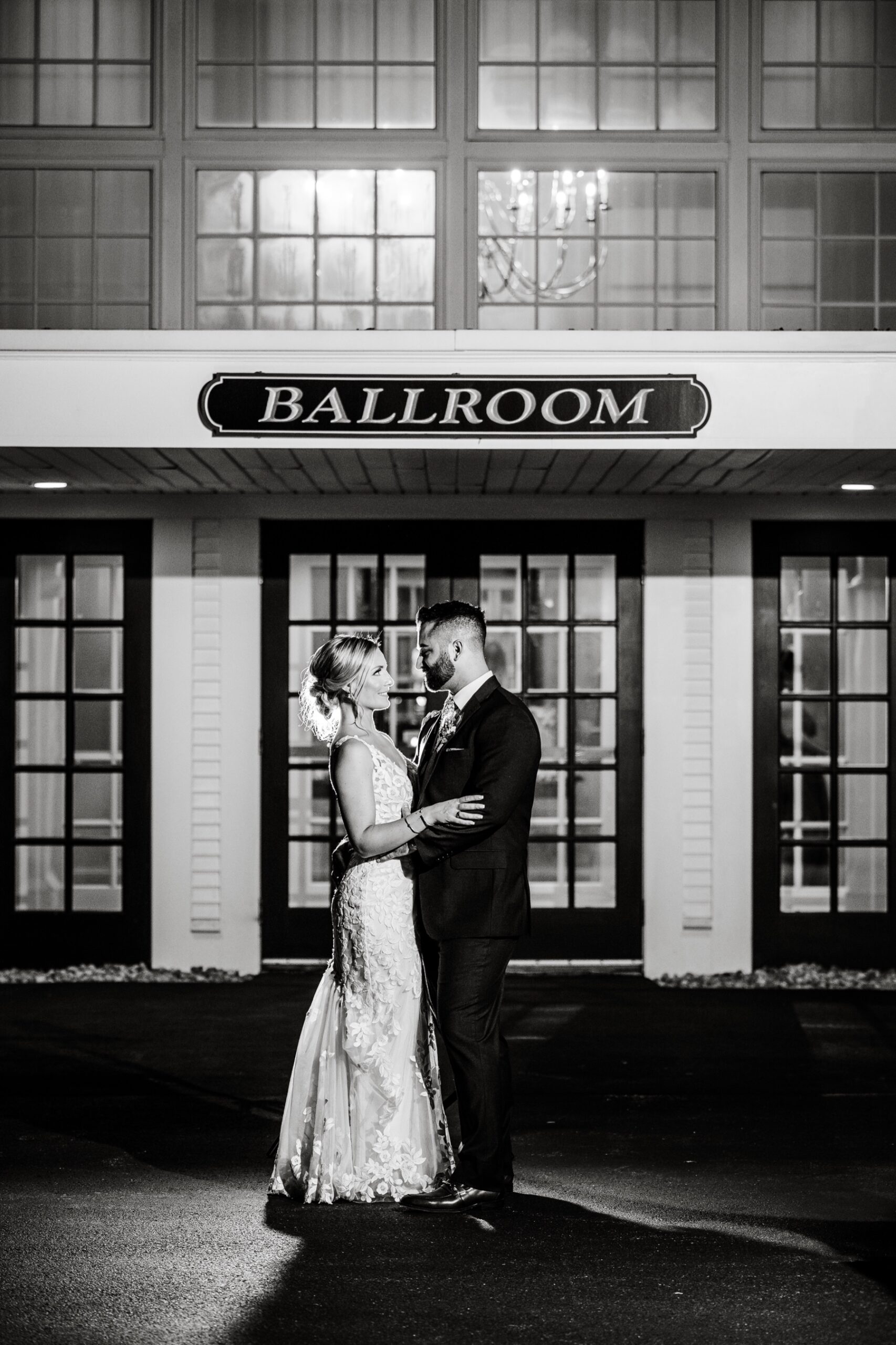 bride and groom standing in front of the entrance to the ballroom of chocksett inn 