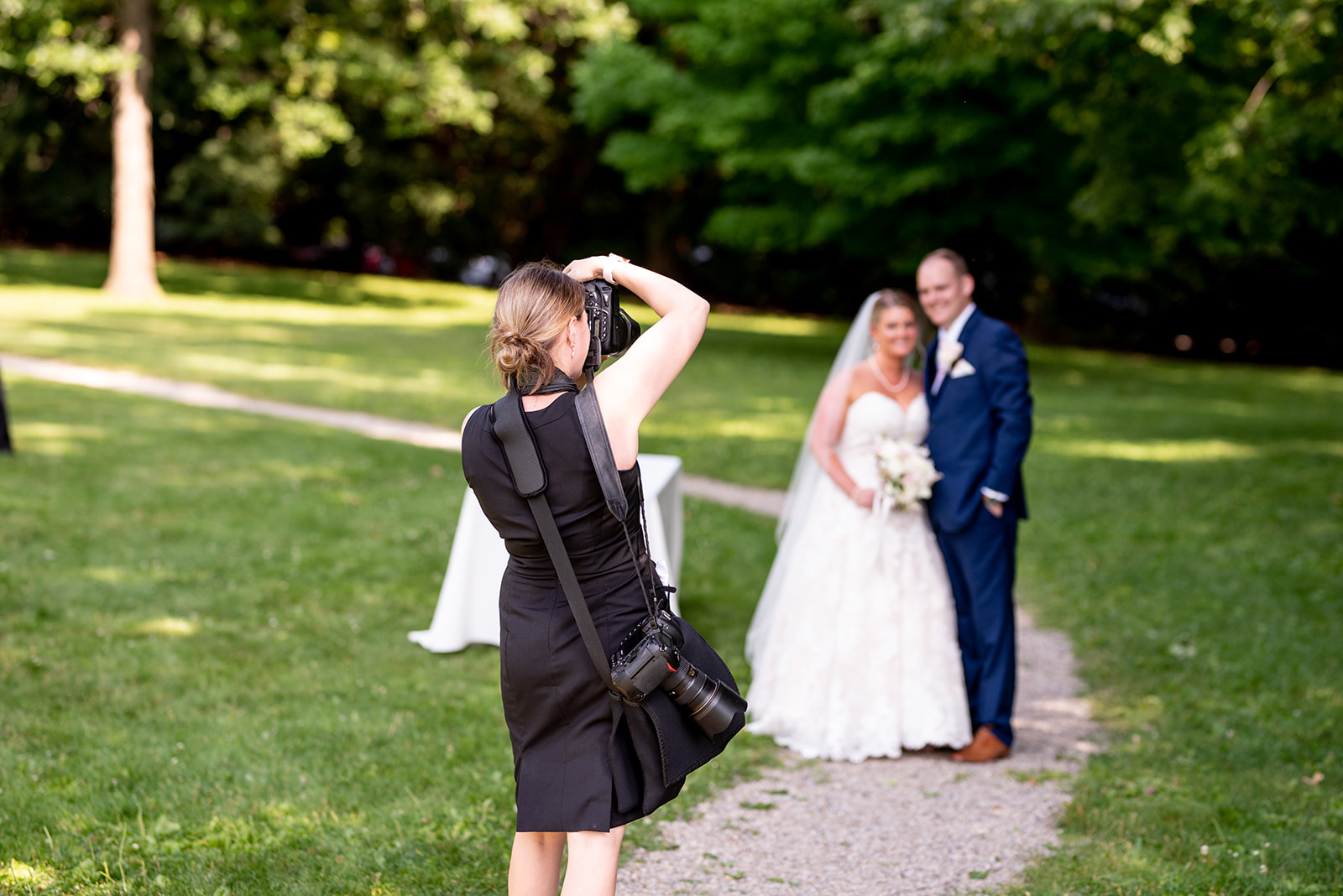 wedding-ready outfits for a photographer includes a black dress 
