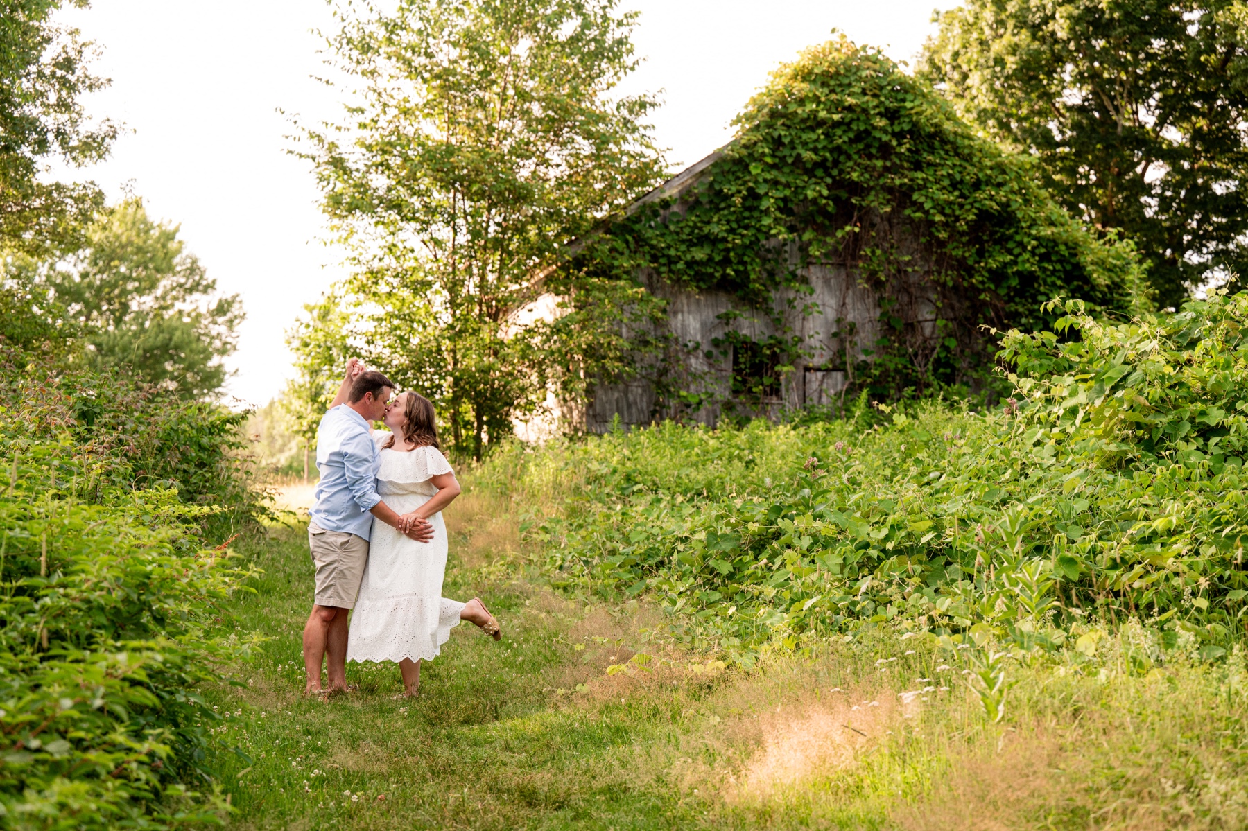 couple dancing in a field for their engagement session