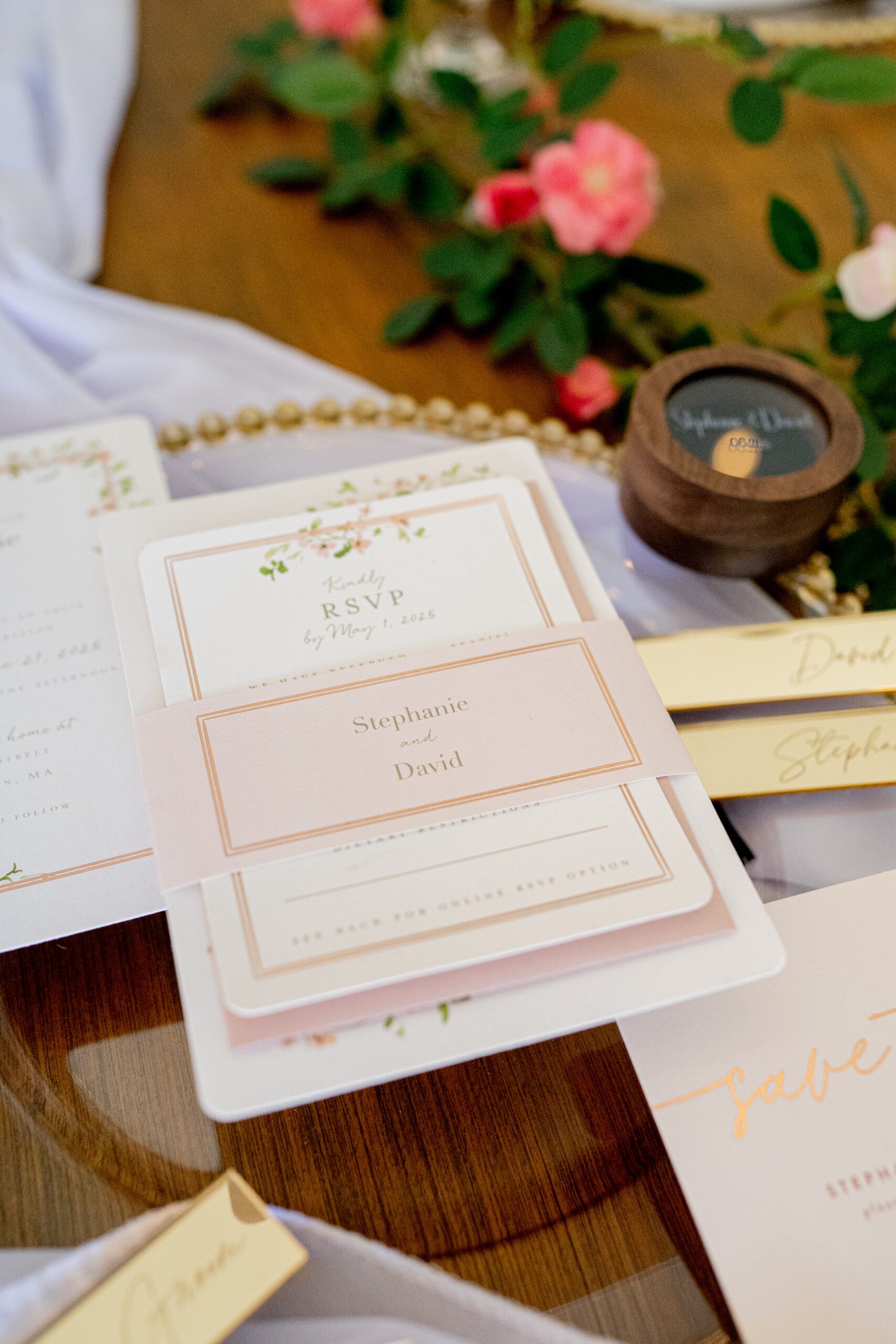 close up photo of wedding invitations and ring box