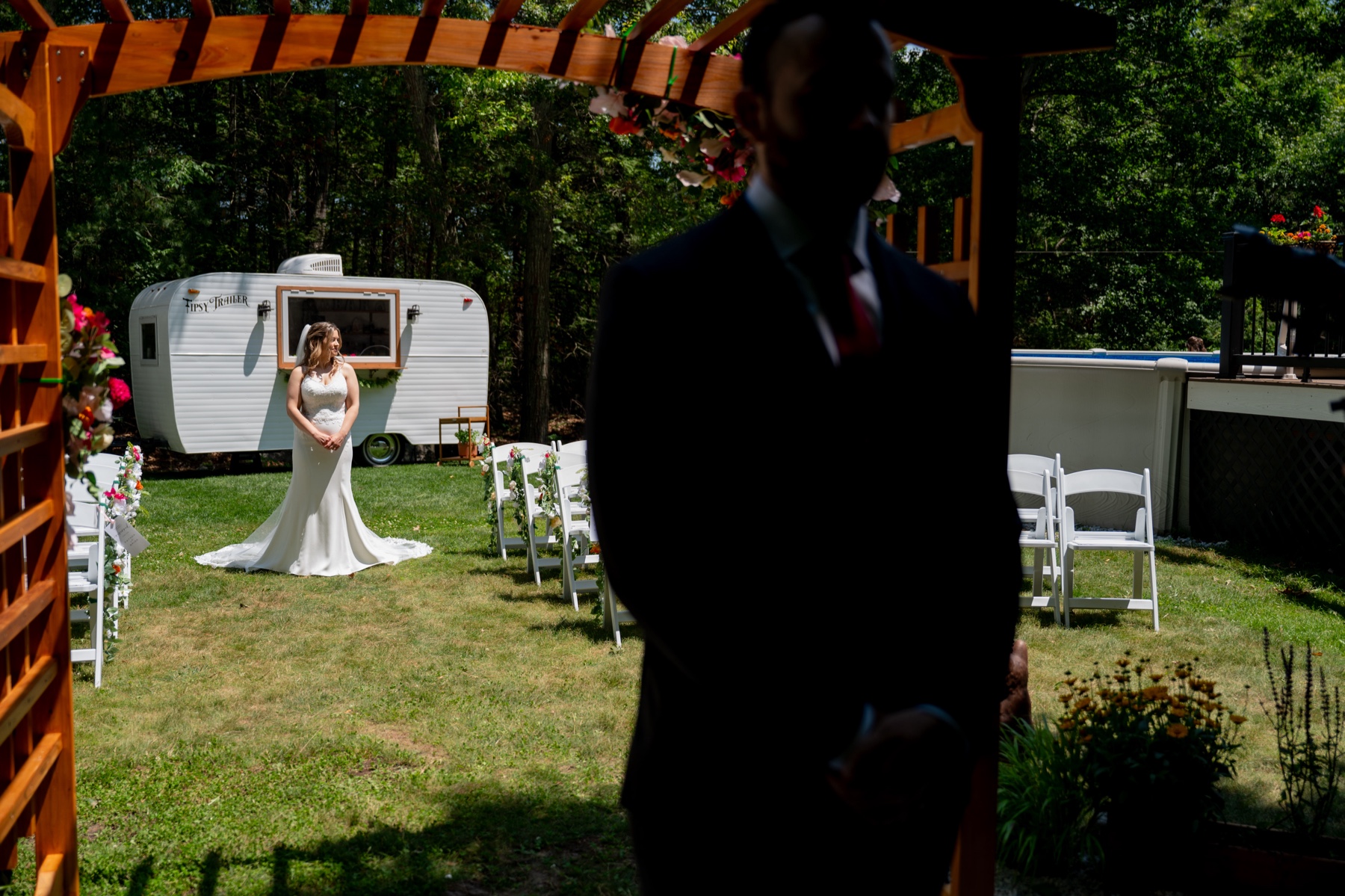 bride standing behind the groom before their first look 