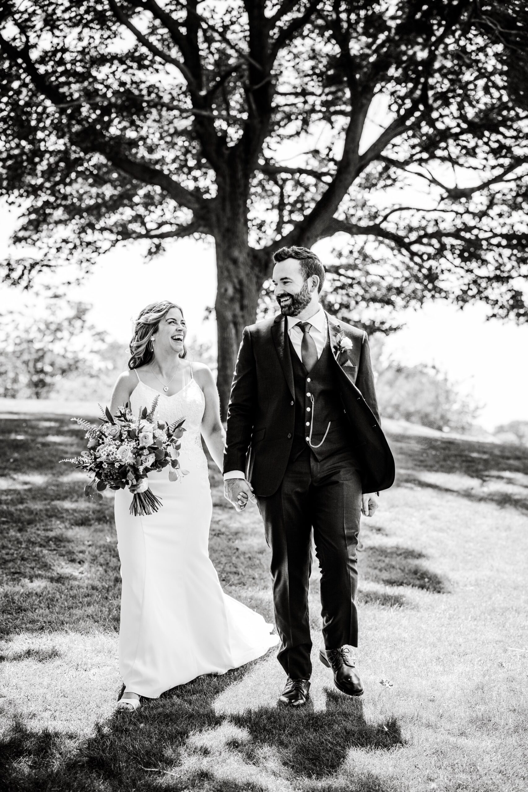 bride and groom smiling at the camera for their pre-wedding ceremony portraits in salem, Massachusetts 