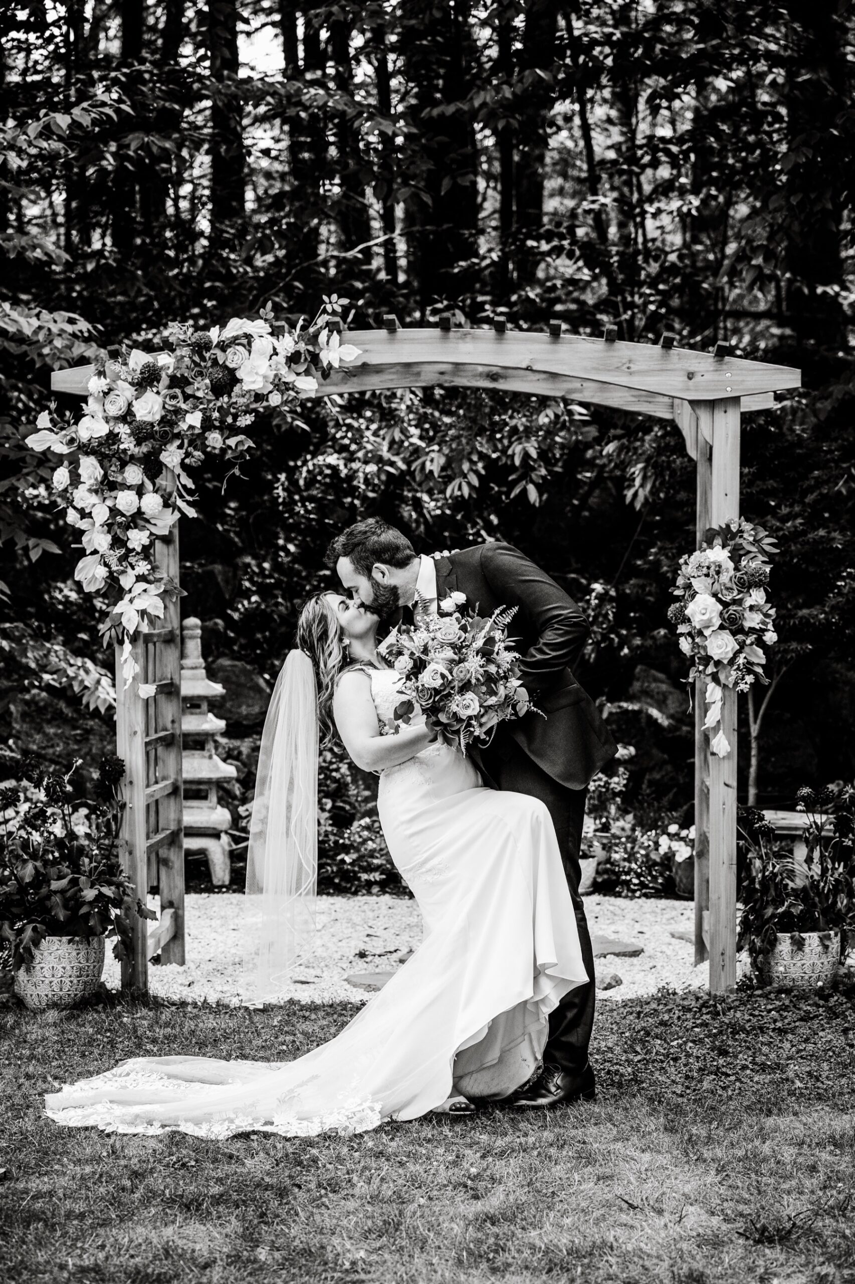 a backyard wedding kiss by the bride and groom