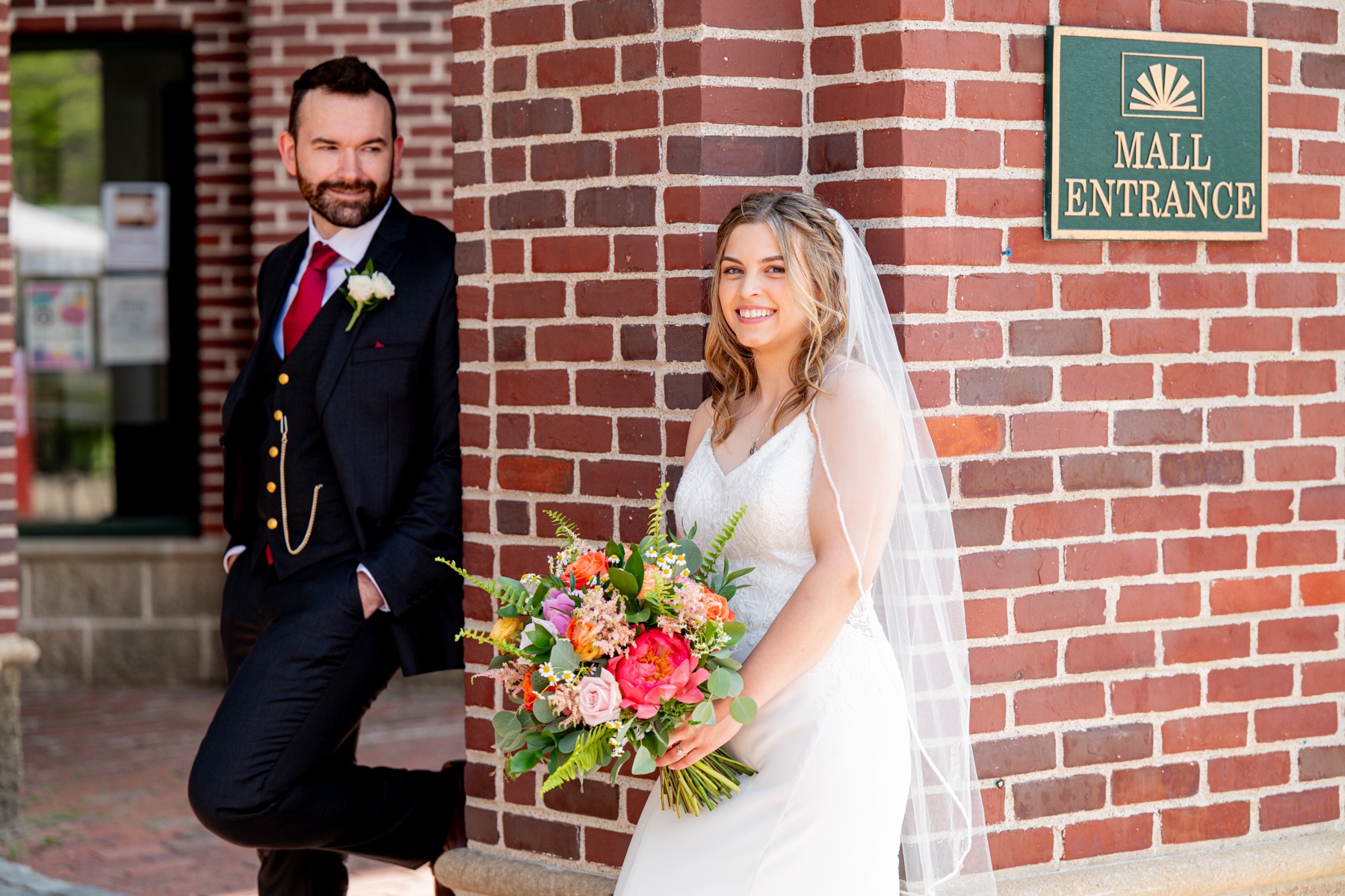 bride and groom standing in front of witch city mall