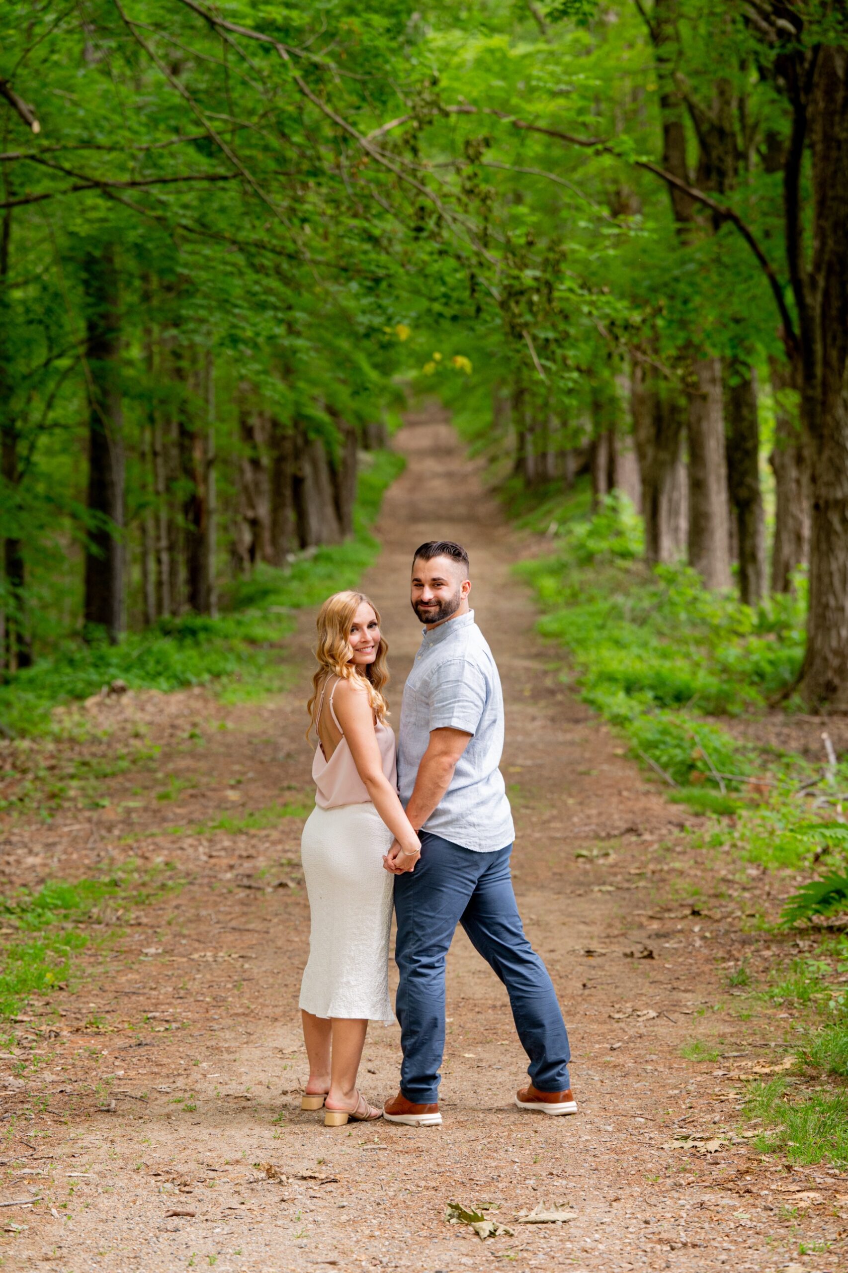 man and woman standing on a dirt path in the moore state park