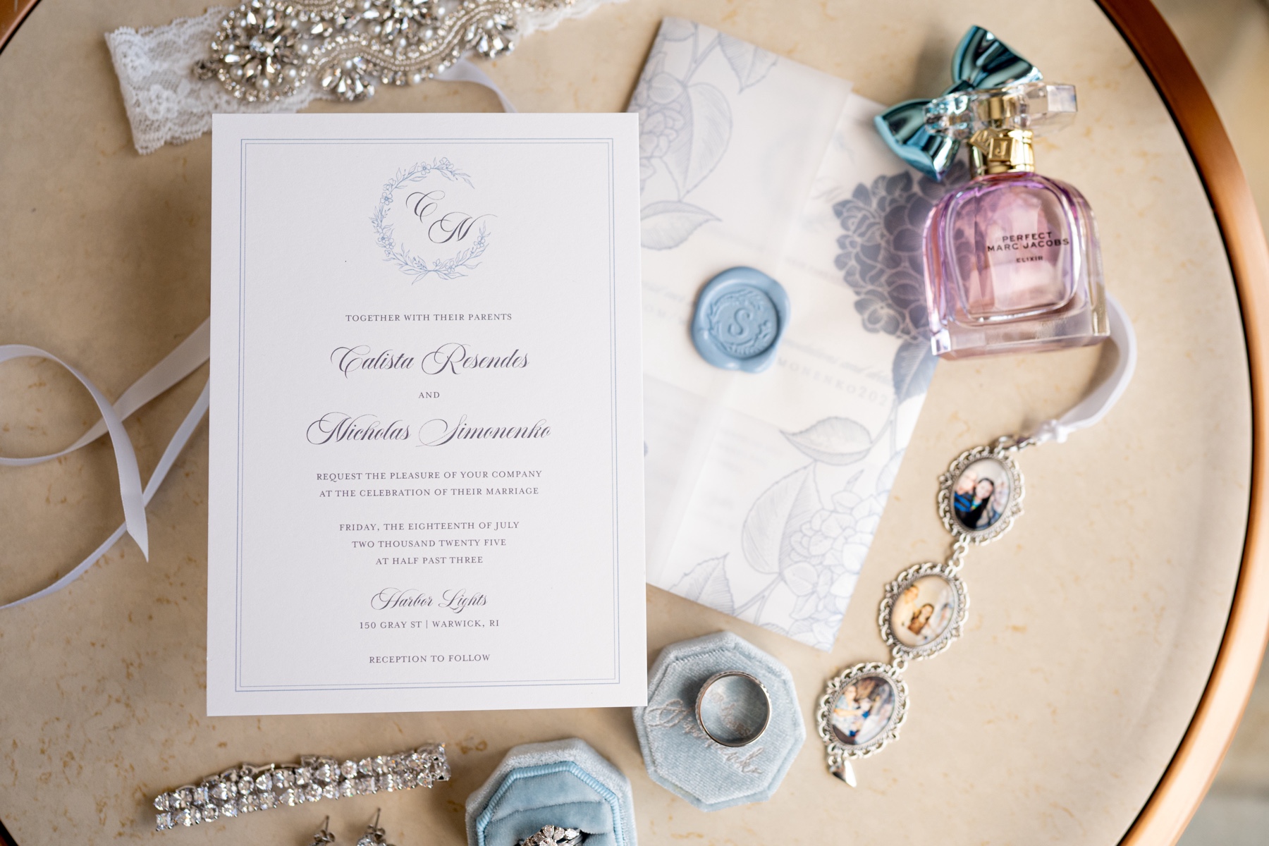 flatlay of bridal jewelry and wedding stationery