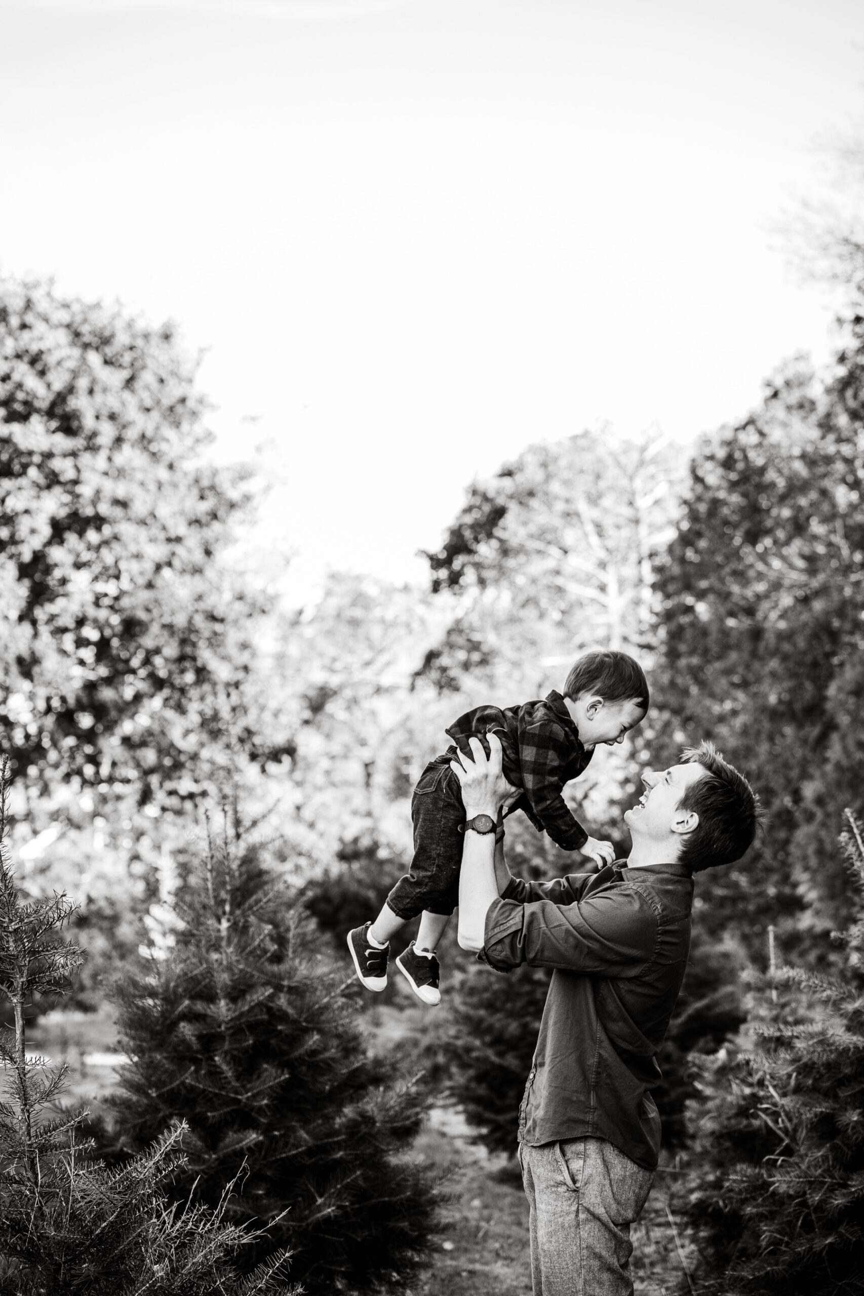 father holding up his son in the air 