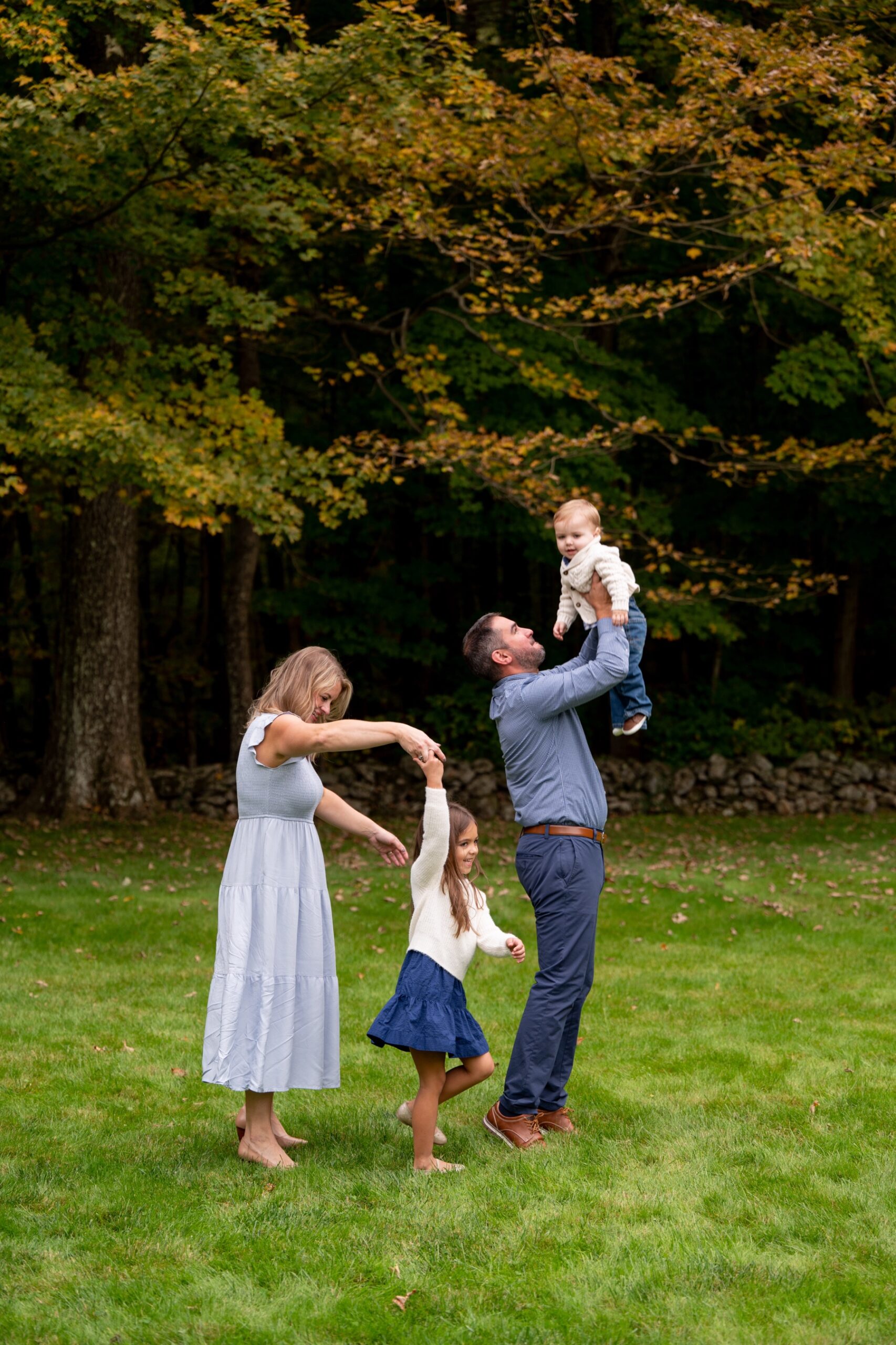 family of four dances in a backyard 