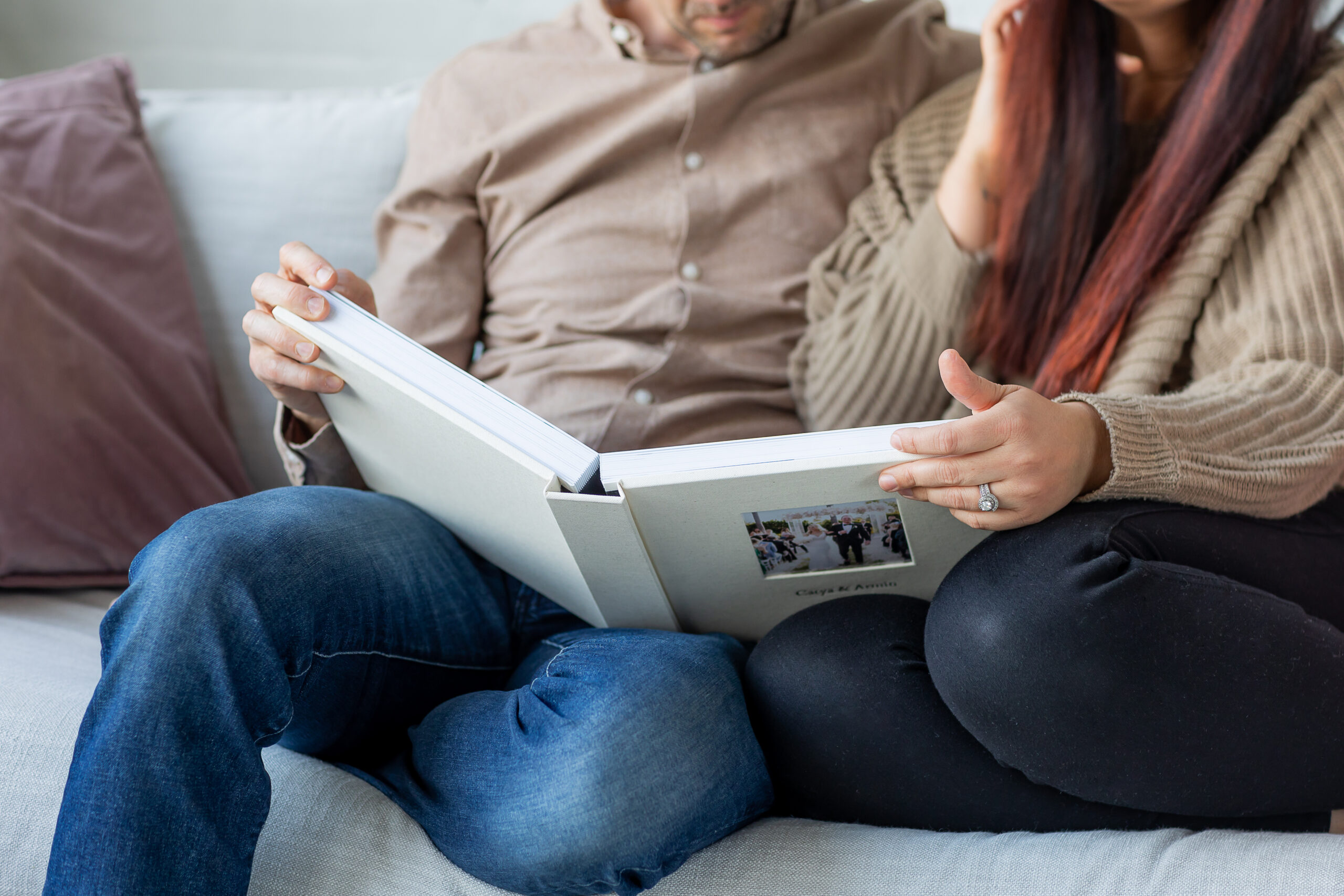 close up of couple looking at their wedding album together 
