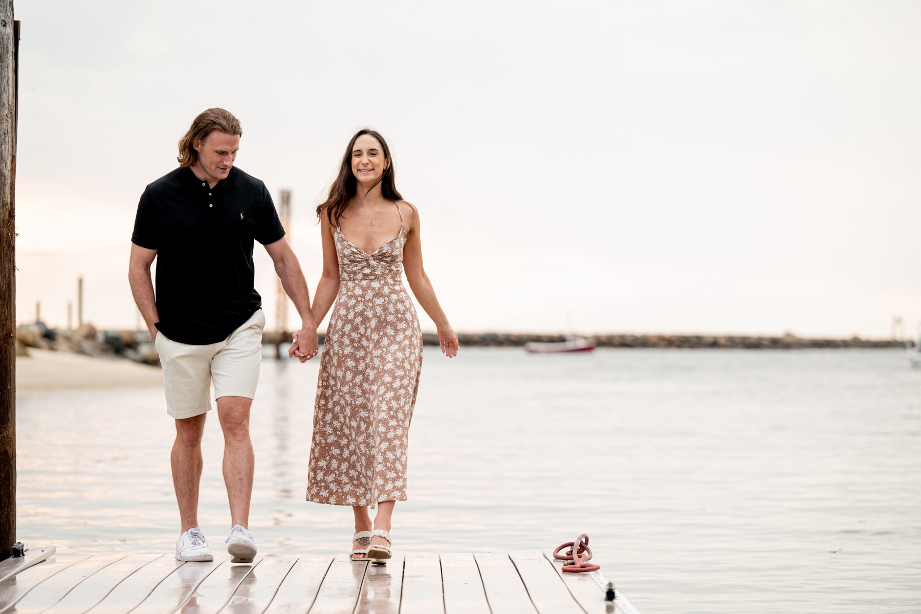 couple walking on a dock in cape cod