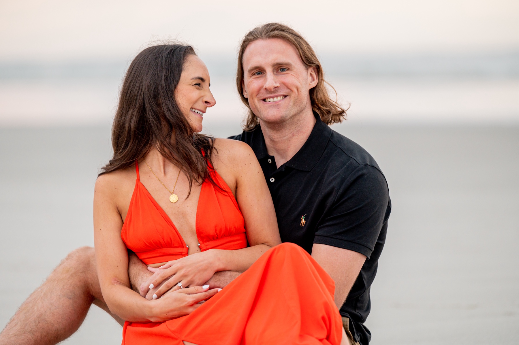 couple sitting on the sand during cape cod engagement session