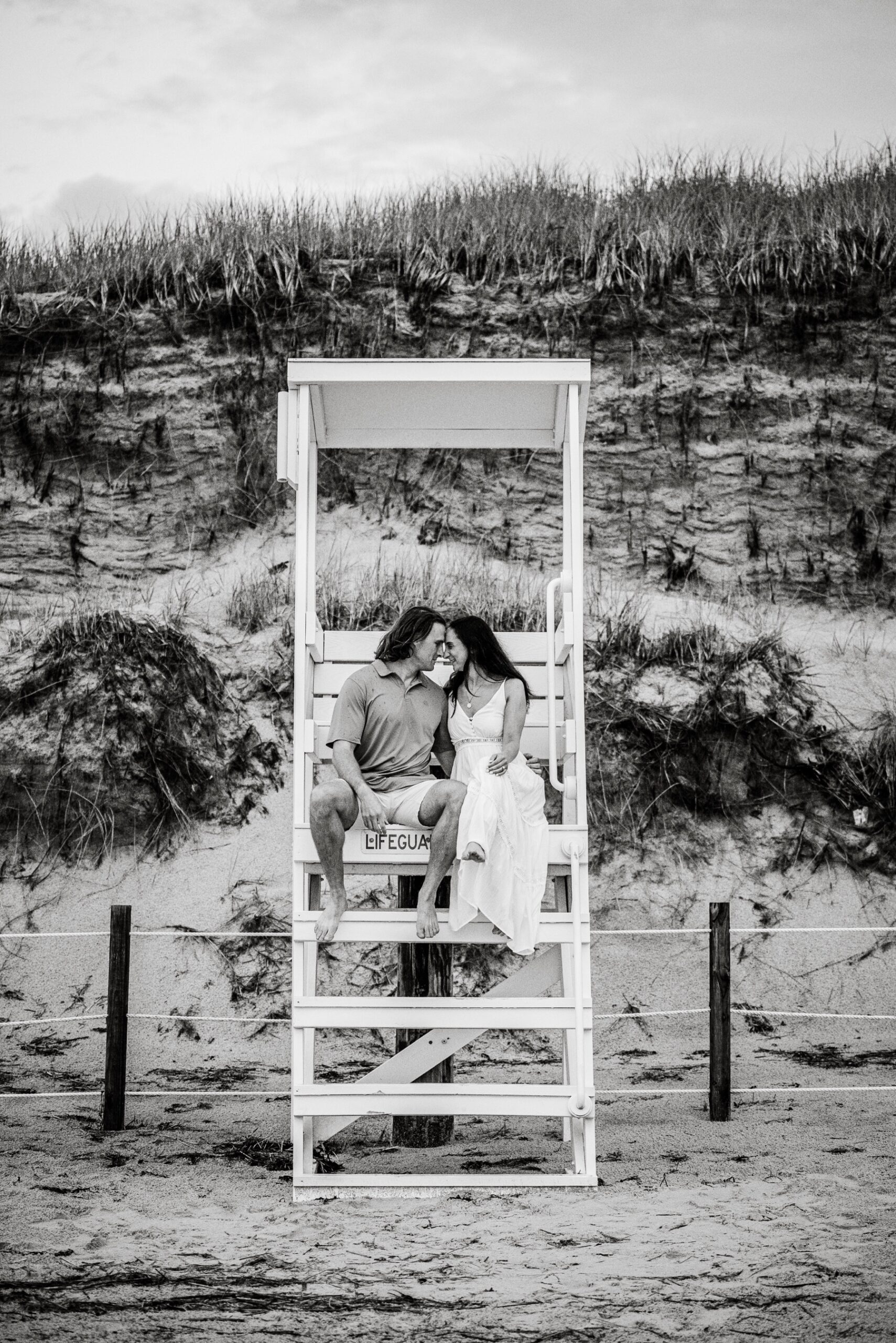 couple sitting in a cape cod lifeguard stand 