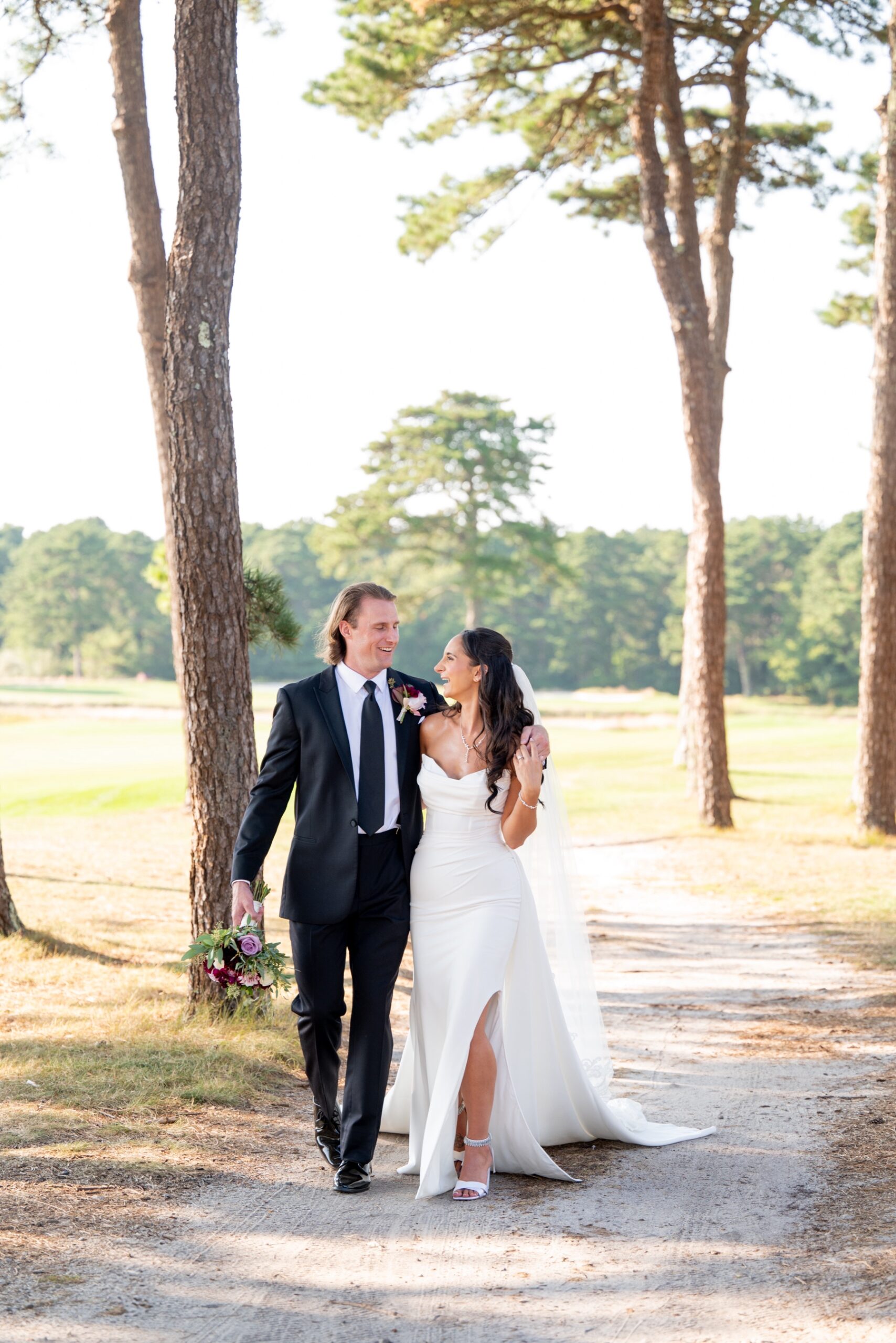 bride and groom walking along the Willowbend Cape Cod Wedding venue 