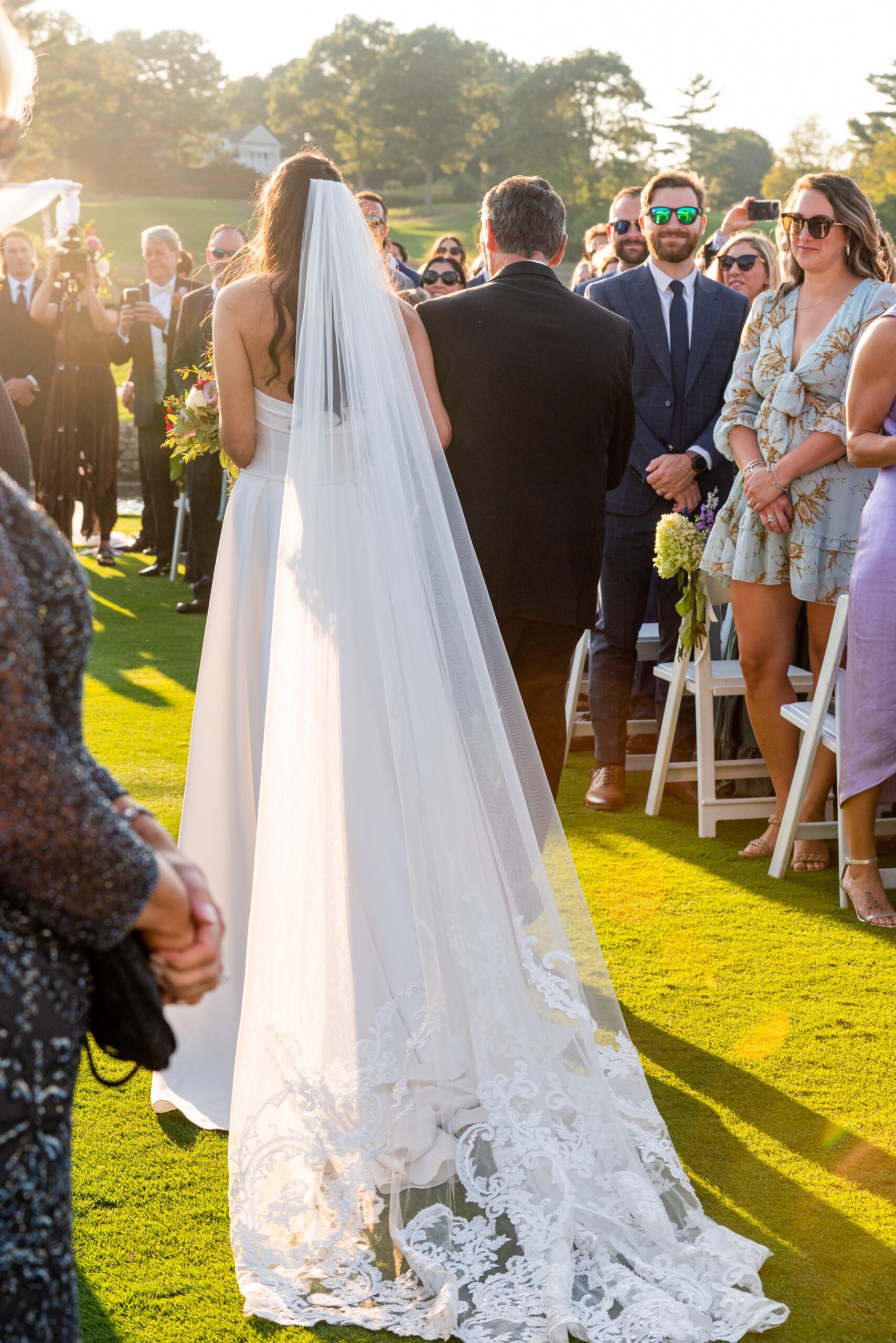 bride walking down the aisle at sunset 
