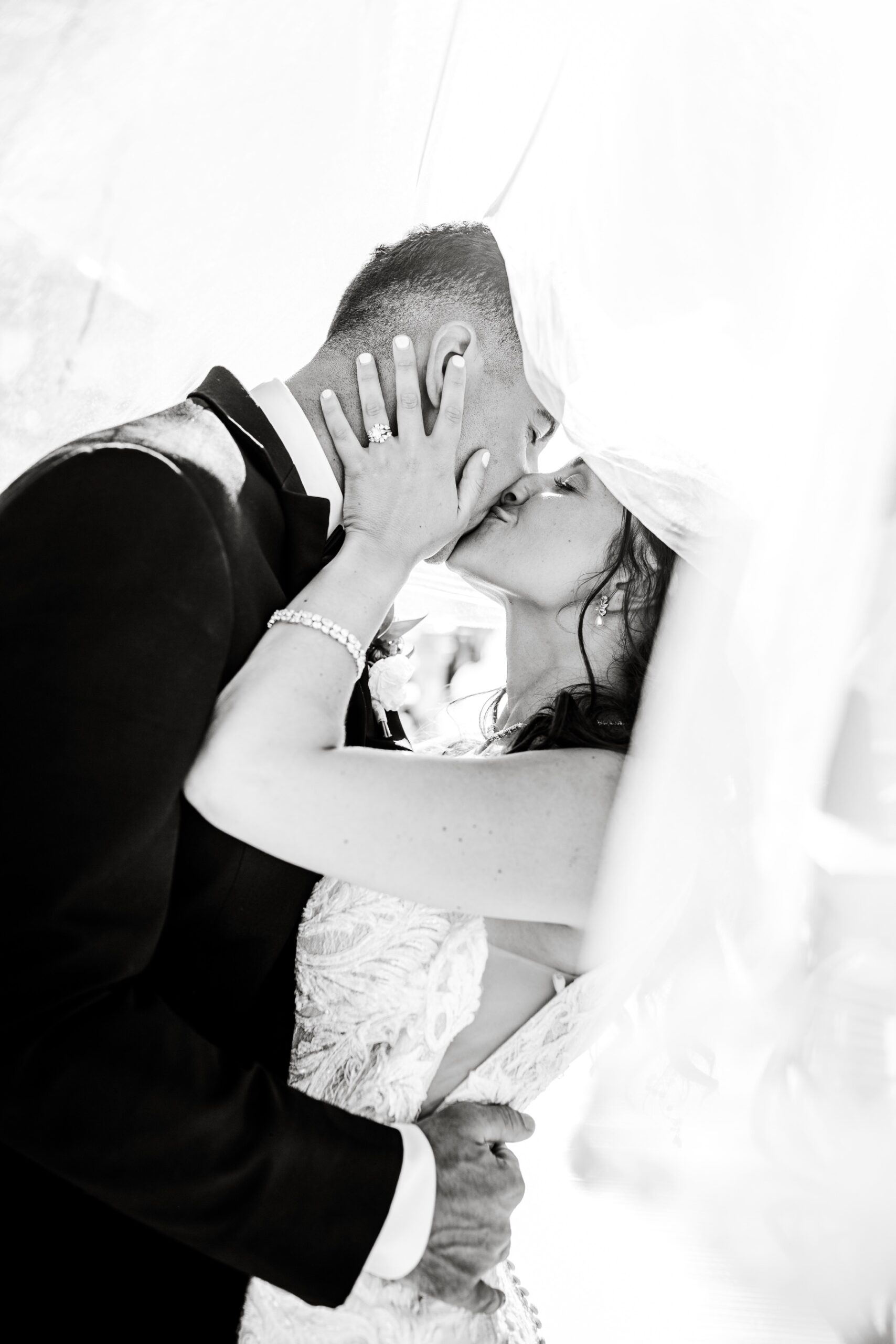bride and groom kissing underneath the bride's veil in warwick ri