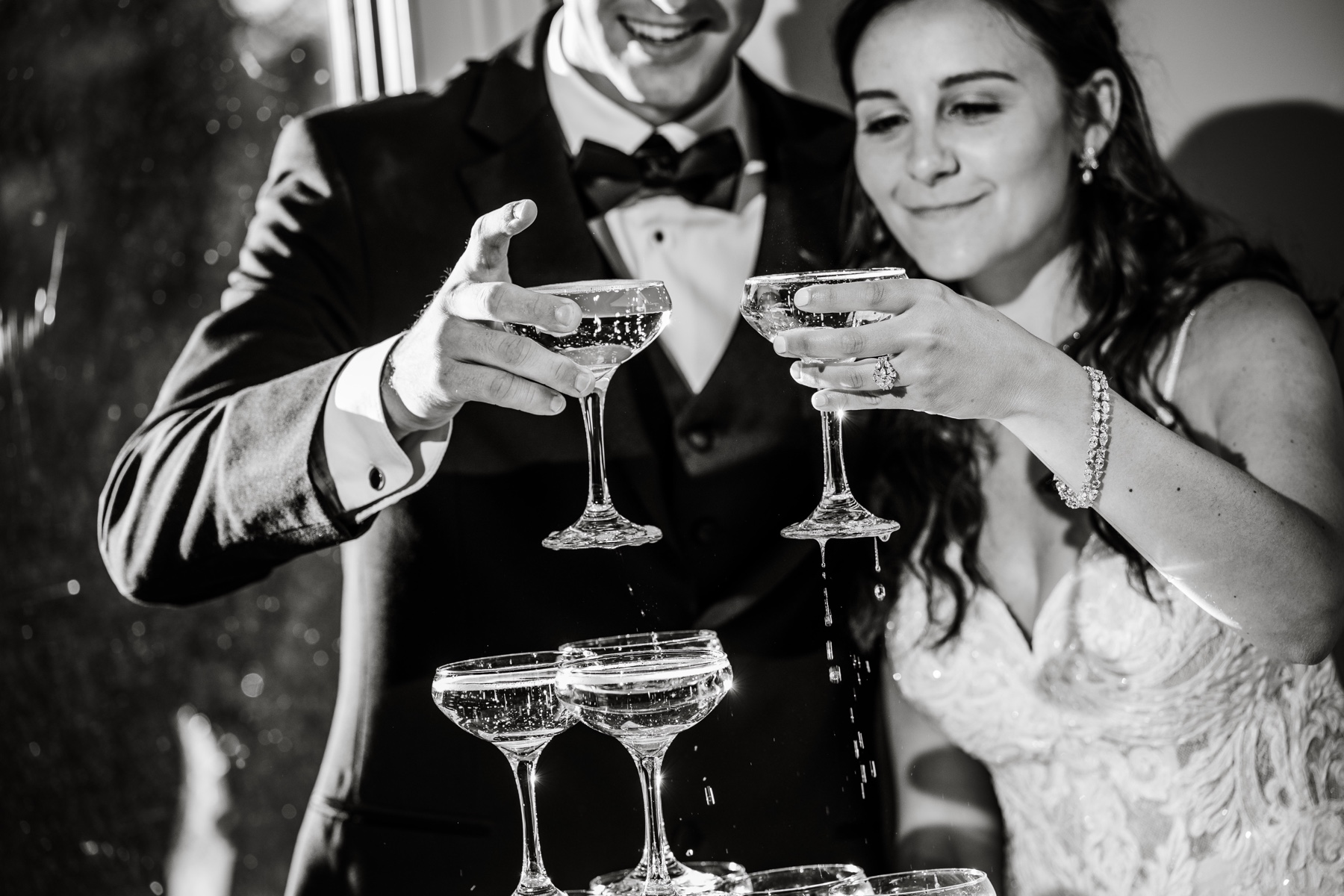 bride & groom pouring in champagne tower