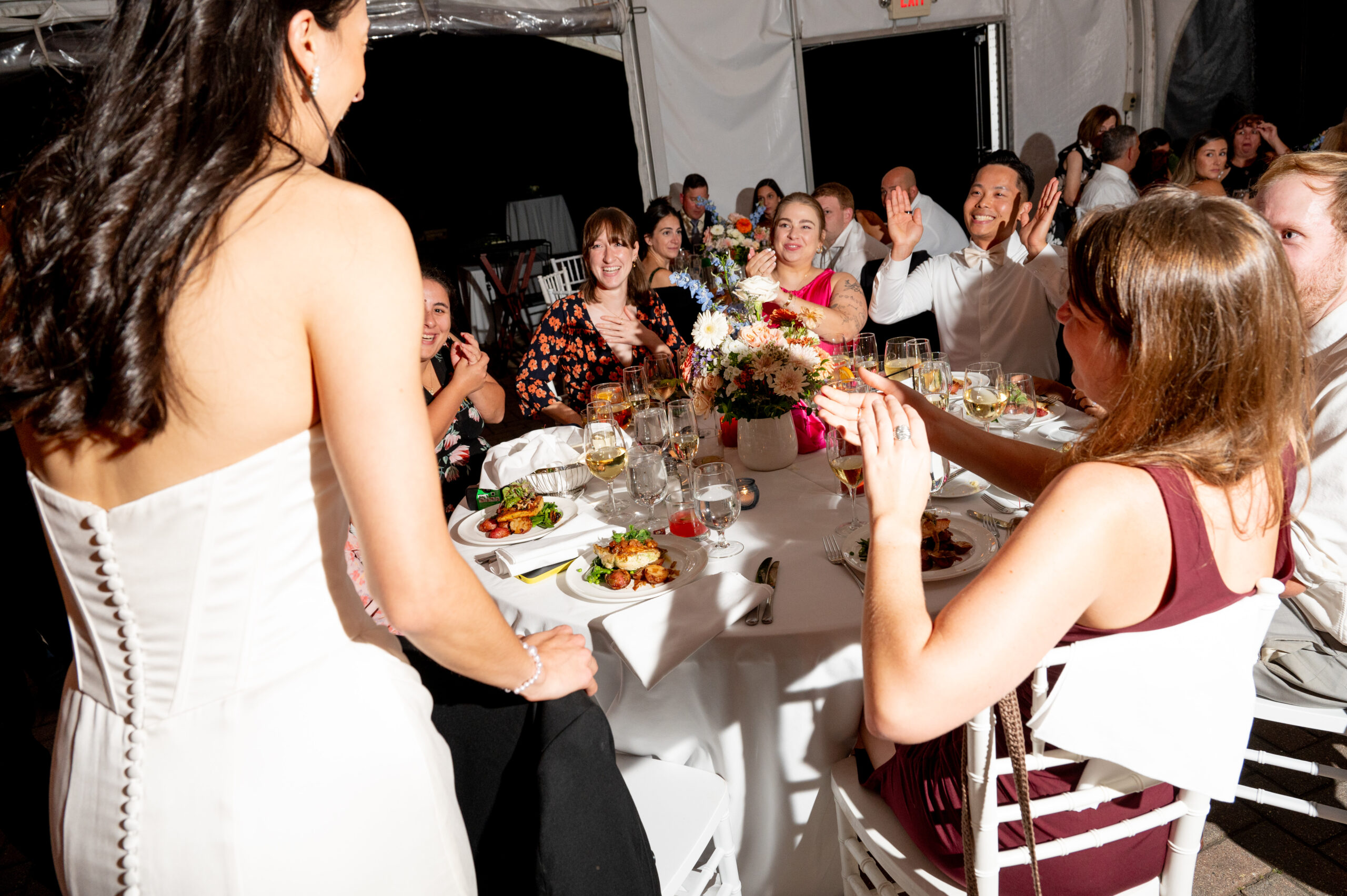 bride visiting guests at a table during the wedding reception