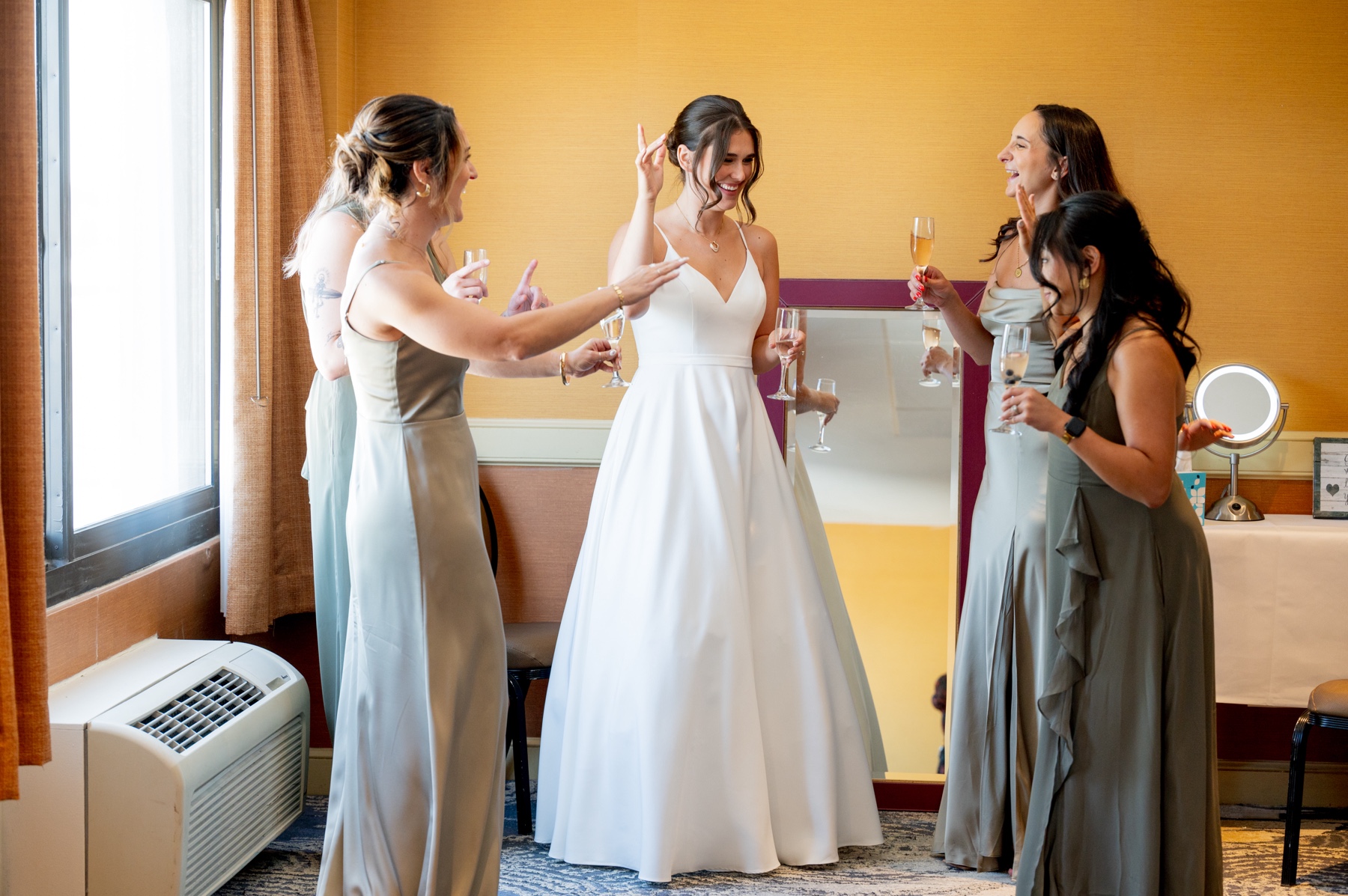 bride & bridesmaids drinking champagne before Terrace Ballroom at Danversport wedding ceremony