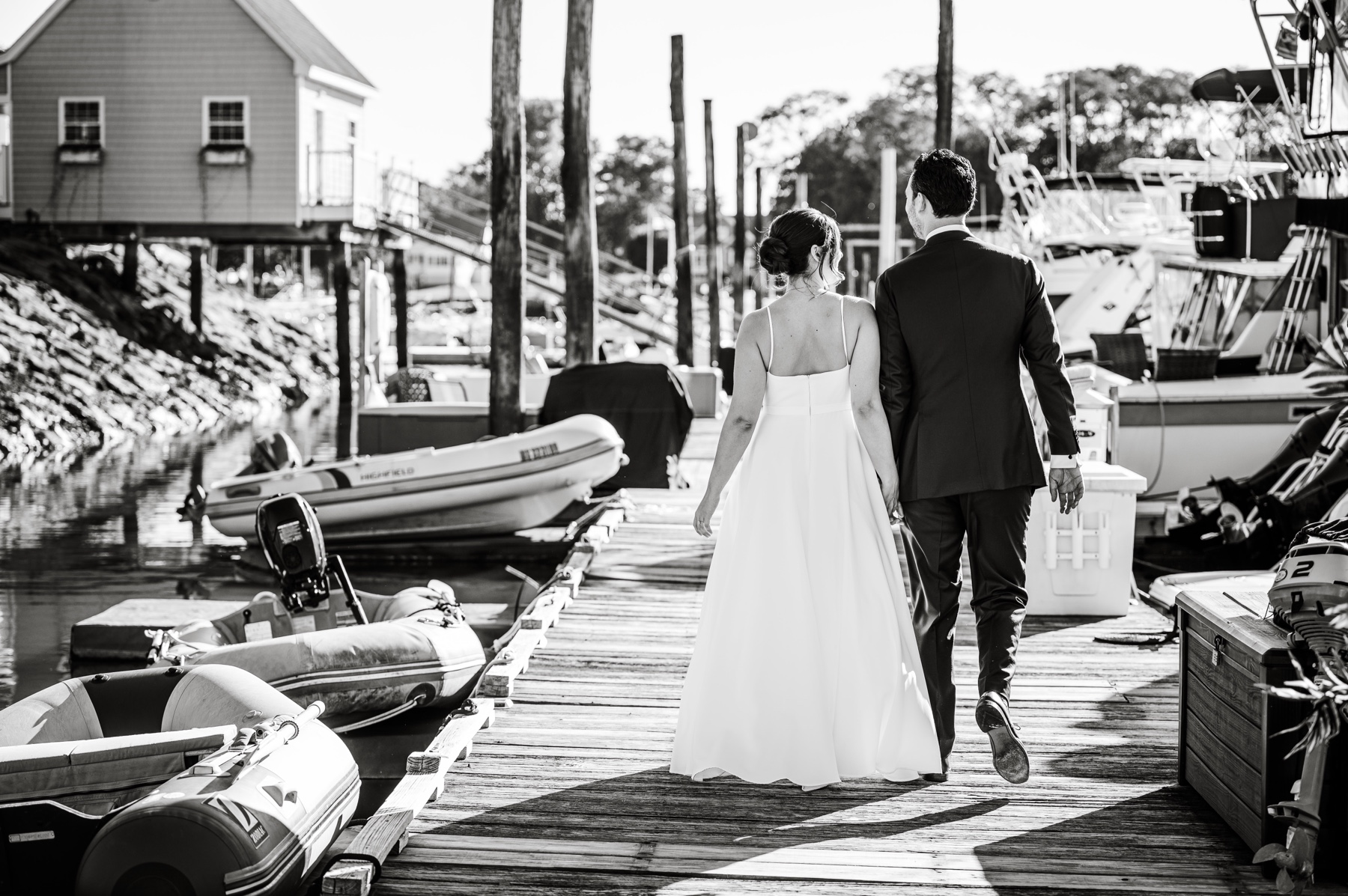 bride and groom walking along marina dock at Danversport