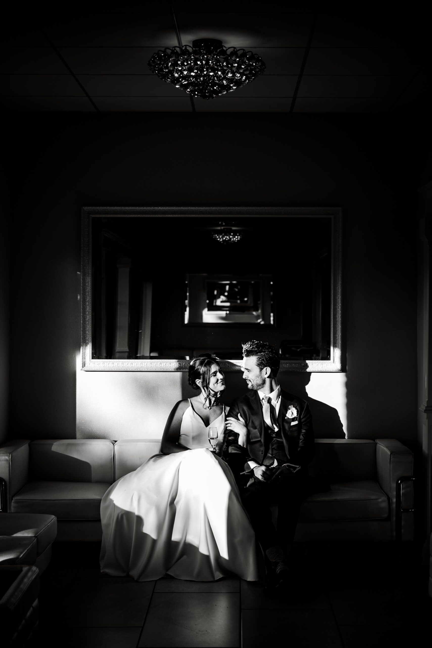 bride and groom sitting on the couch after wedding ceremony at Terrace Ballroom at Danversport