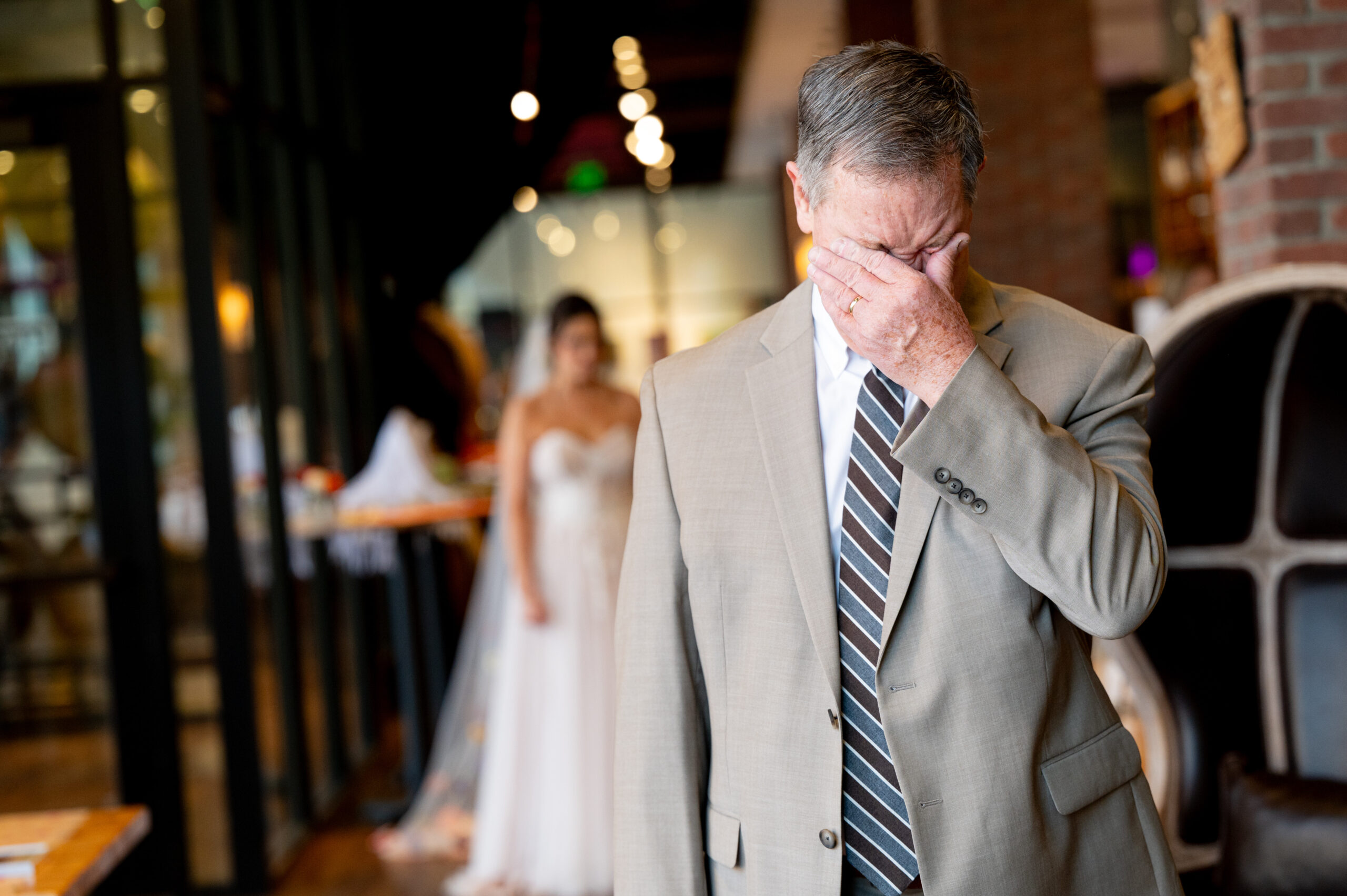 Your Photographer Is More Than Someone Who Takes Photos, they capture the emotional moment of the father of the bride wipes his eyes just before seeing his daughter in her wedding dress