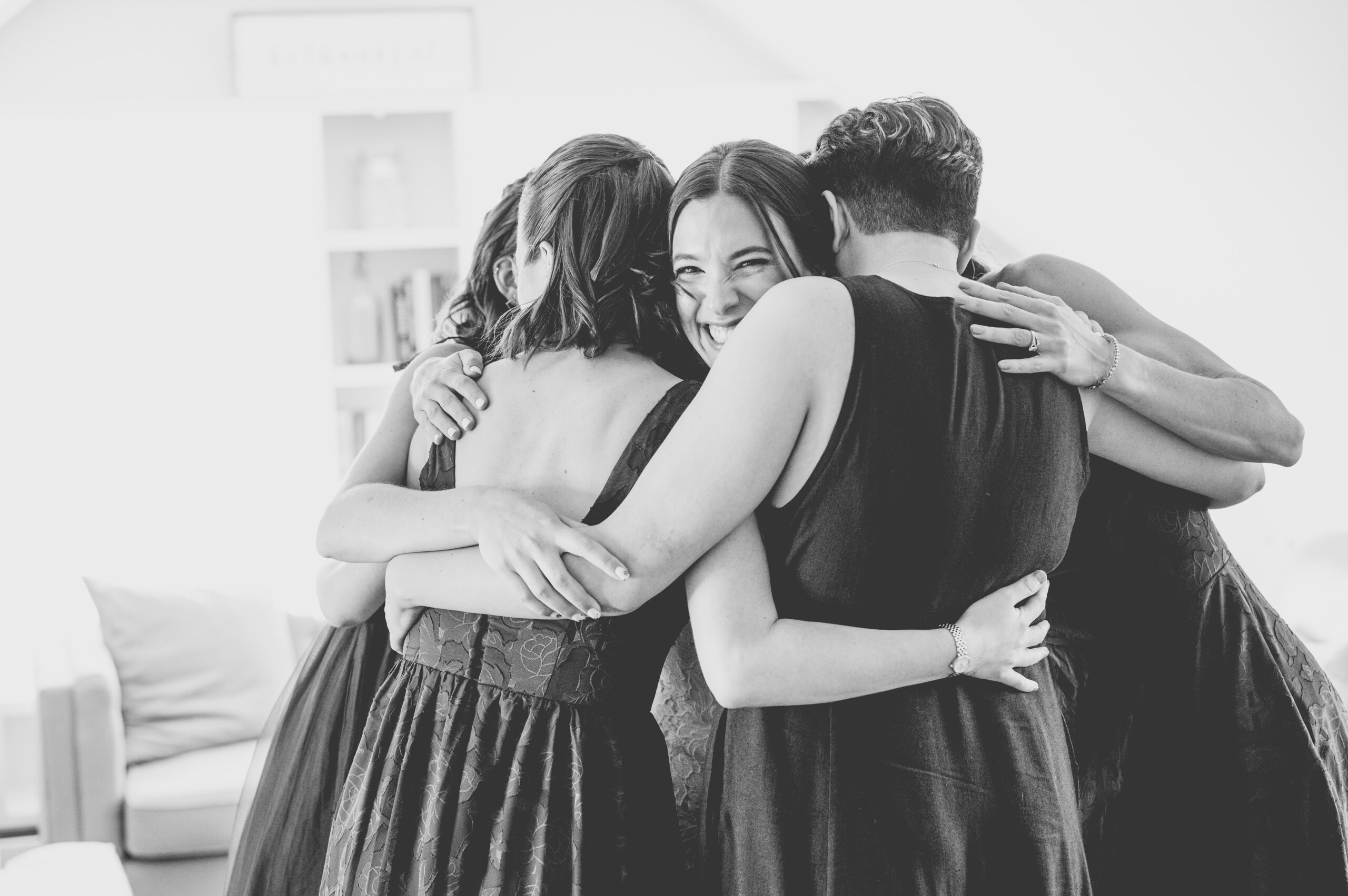 bridesmaids hugging bride before wedding ceremony