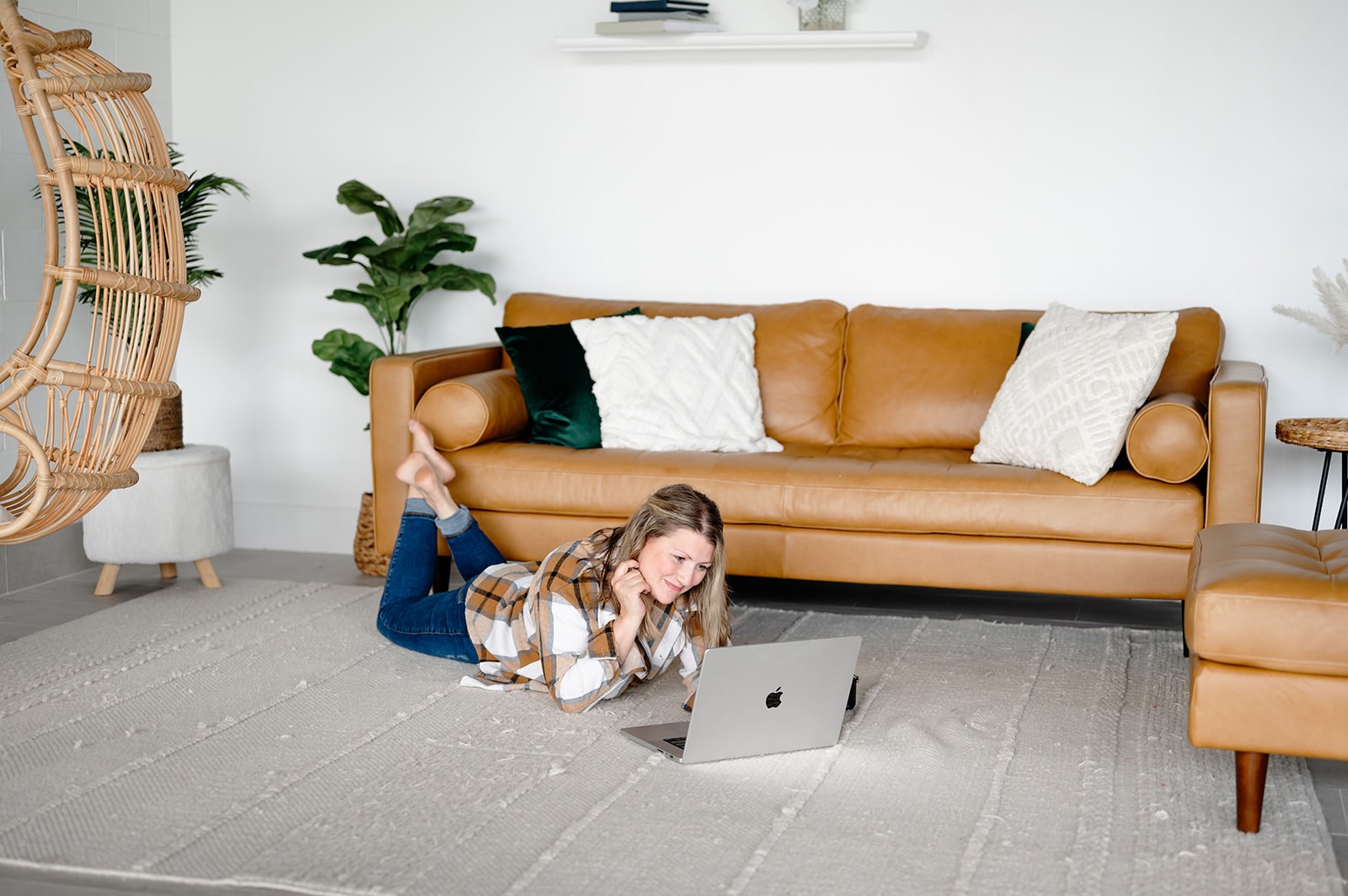 Ali lying on the floor working on her laptop