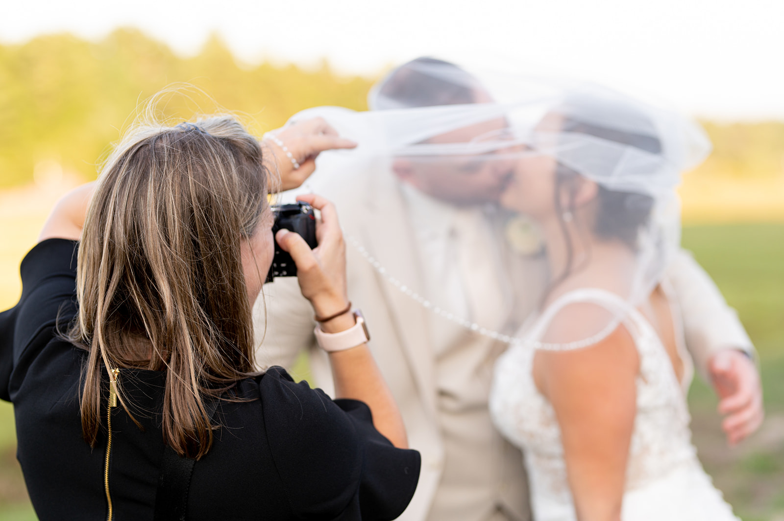 Ali taking veil photo of bride and groom